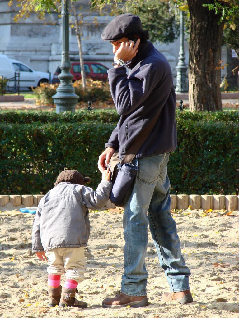 Father holding a child in a public park on the Pest side of Budapest
