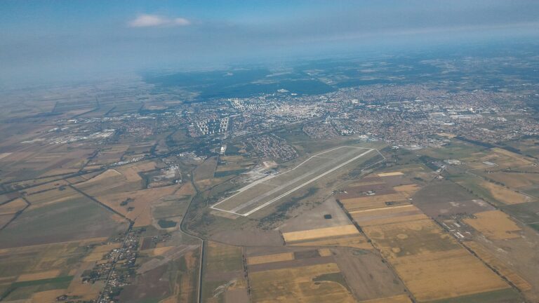 Aerial view of Debrecen Airport’s runway with the city beyond
